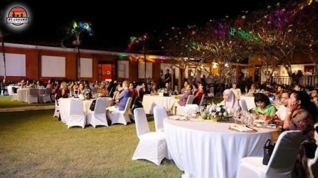 Corporate guests enjoying a luxury gala dinner on a Bali beach with elegant outdoor dining setup